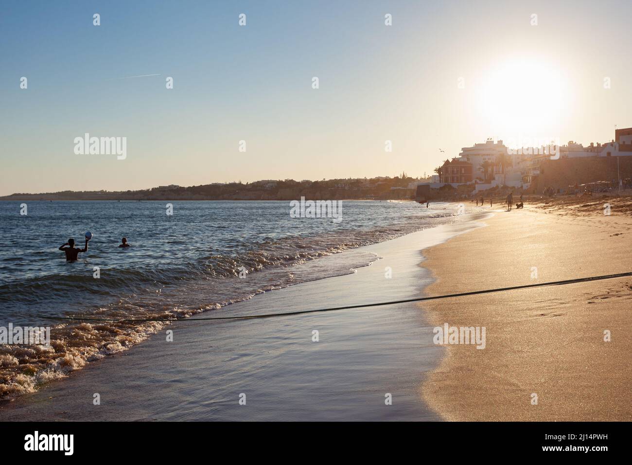 Sunset over the beach of the Portuguese seaside town of Armação de Pêra in the southern region of the Algarve, Portugal. Stock Photo
