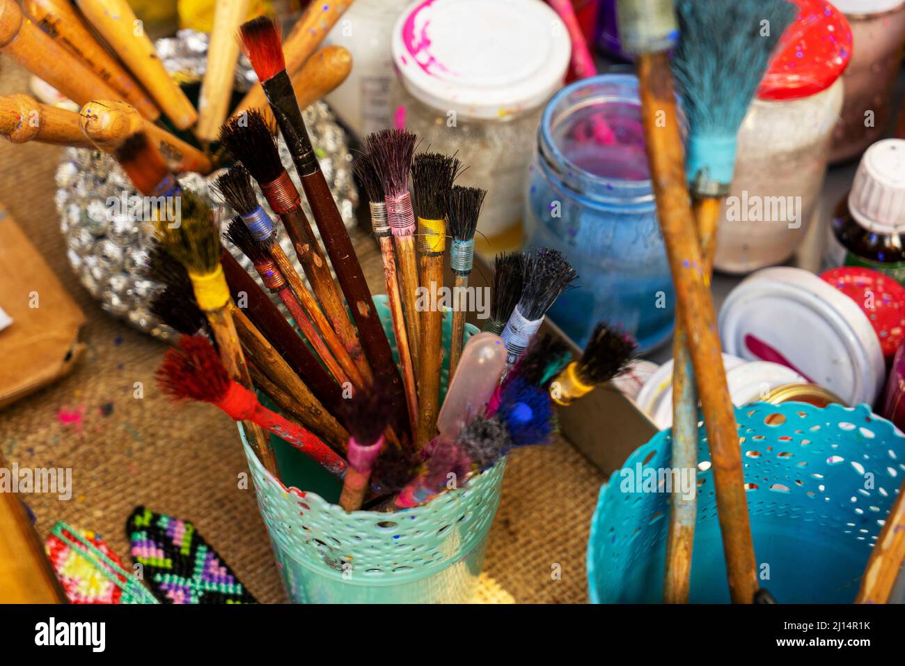 colorful paints in bottles, bottles and brushes for drawing Stock Photo