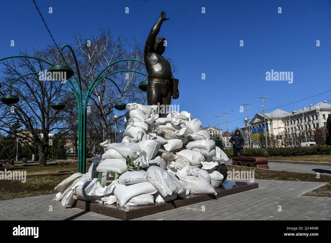 ZAPORIZHZHIA, UKRAINE - MARCH 22, 2022 - Sandbags piled by local volunteers, historians and museum employees seal the monument to Ukrainian weightlift Stock Photo