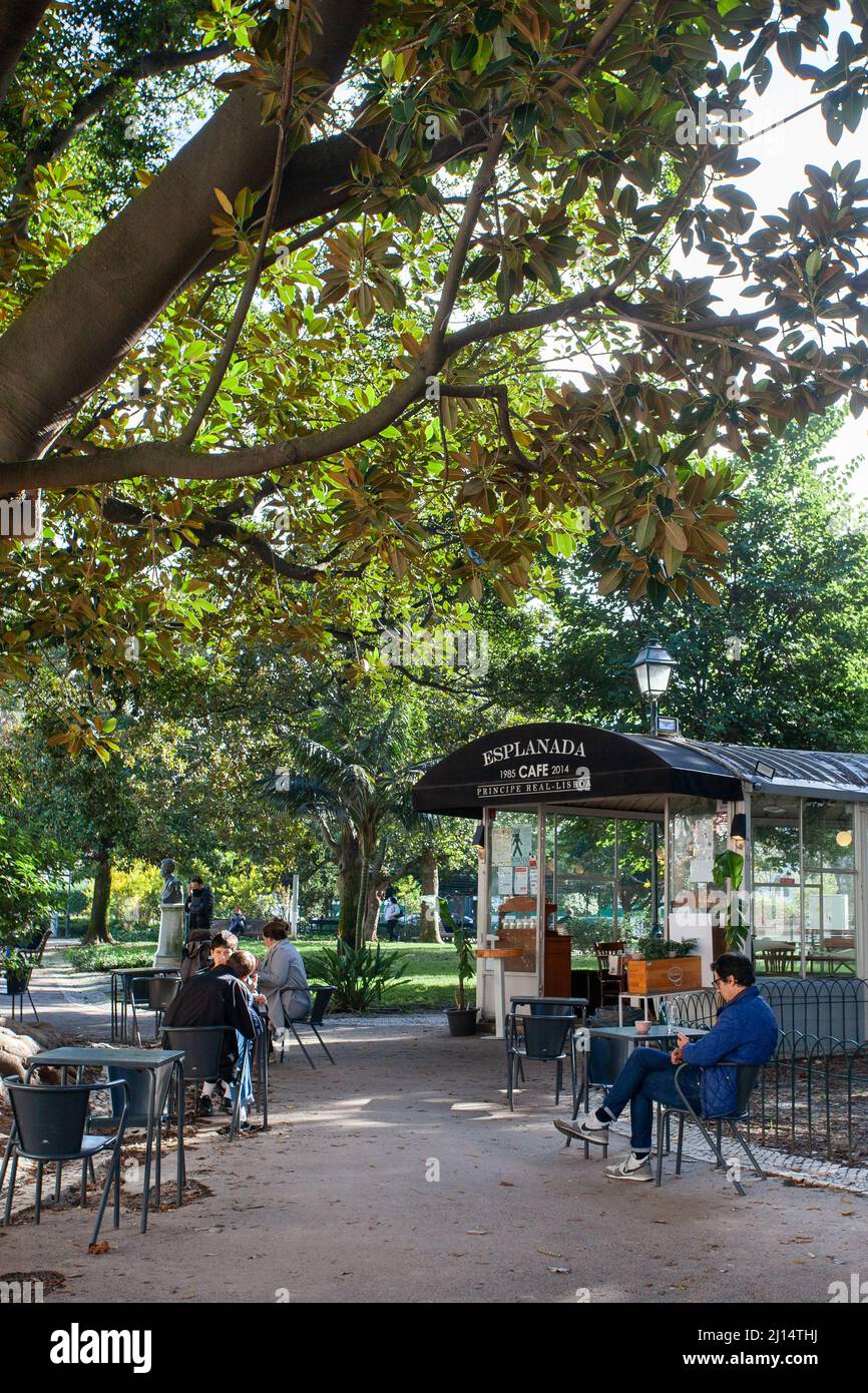 Tourists relaxing on the terrace of the café in the lush Principe Real garden, (Jardim do Príncipe Real) located in the centre of Lisbon, Portugal. Stock Photo