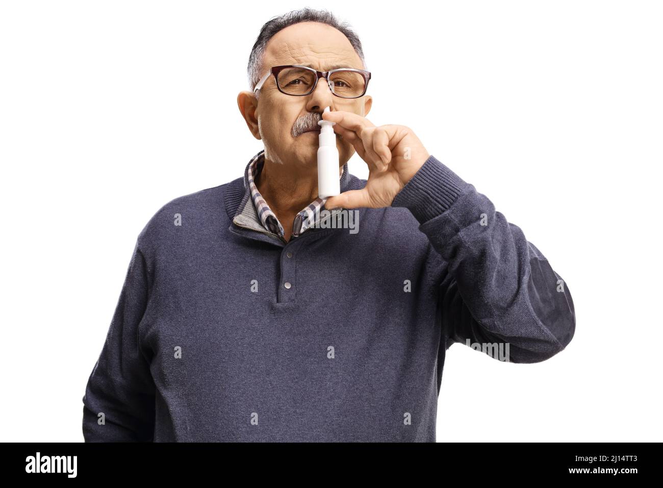 Mature man using a nasal spray isolated on white background Stock Photo