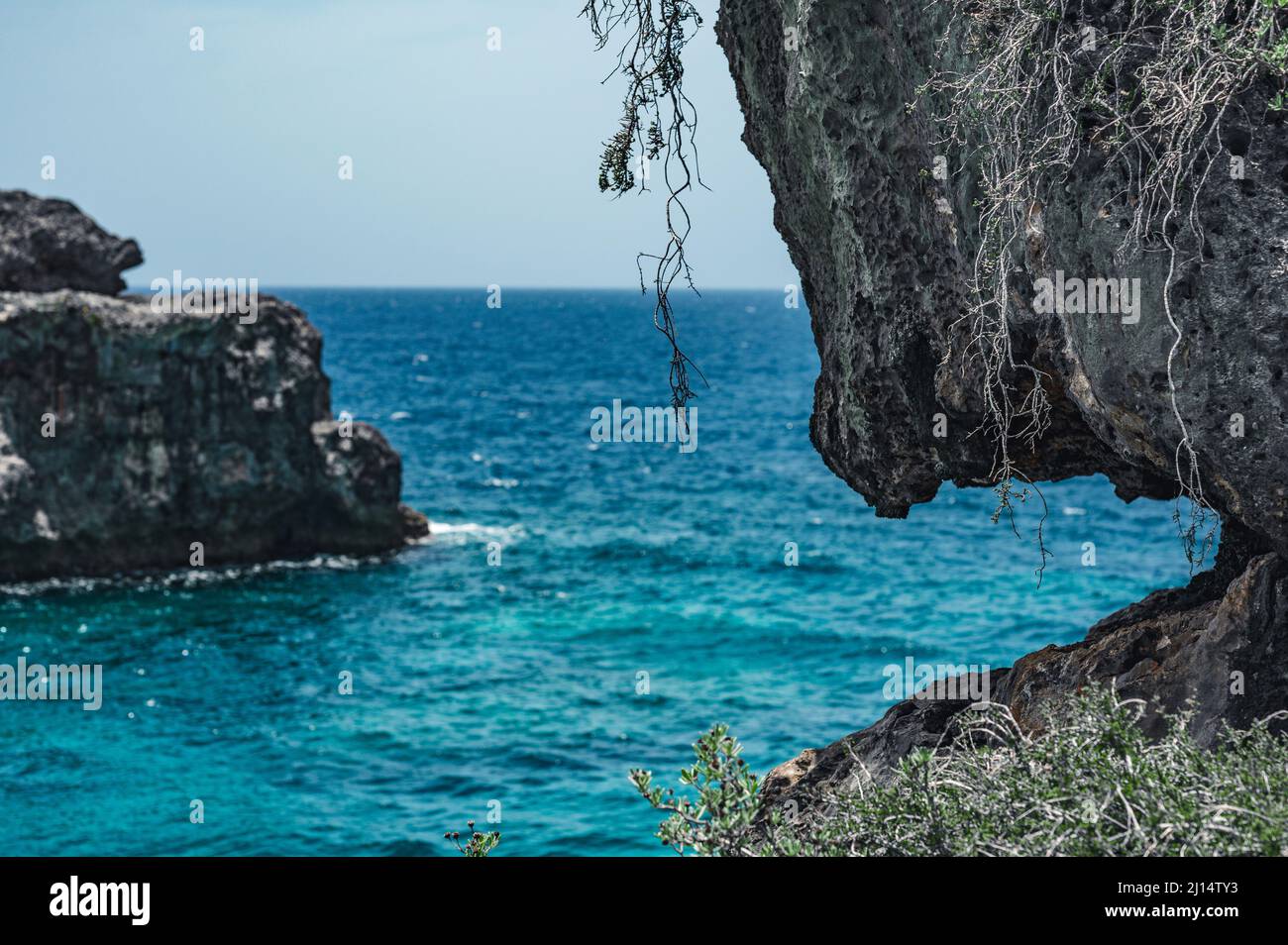 The photo shows the Atlantic Ocean with a rocky coast. The exotic island's beach contains many rocks and grottoes. The rocky landscape and the sea are Stock Photo