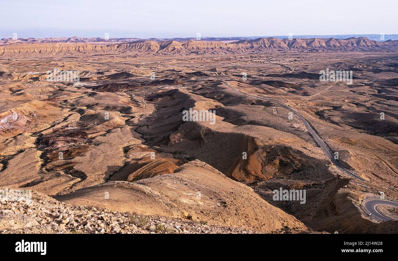 golden hour view of Hamakhtesh Hagadol the Large Crater in Negev Desert in Israel from the Mt Har Avnon overlook showing the colorful geology of the e Stock Photo