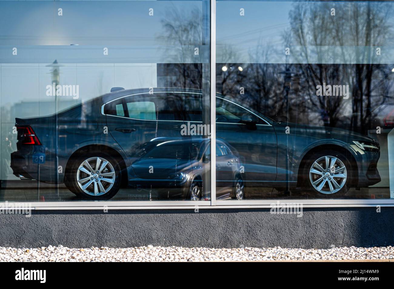 Riga, Latvia, March 18, 2022: View of the new Volvo through the window. The glass reflects the car parked outside. Stock Photo