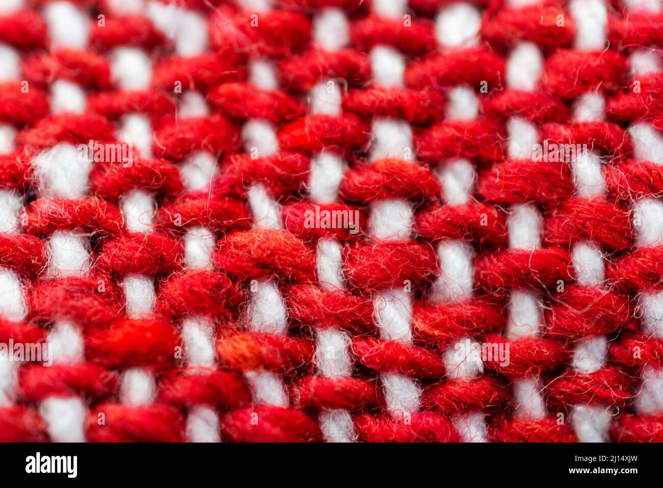 A close up view of a red and white woven blanket. Stock Photo