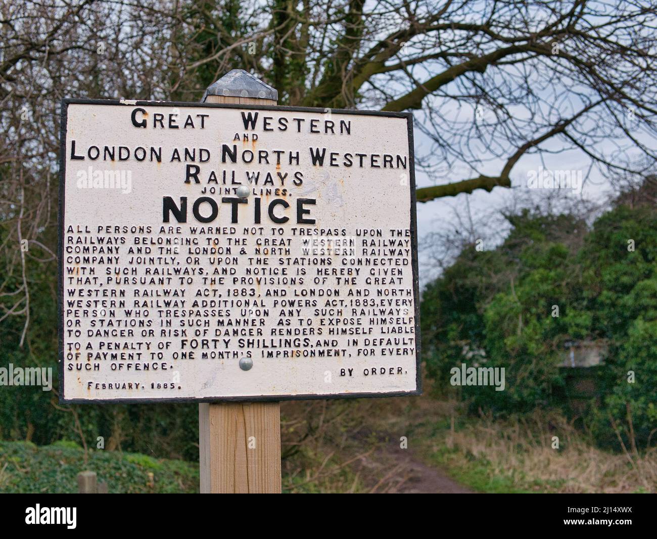 Dated February 1885, a sign from Great Western Railways and London and North Western Railways warns against trespass on their property Stock Photo
