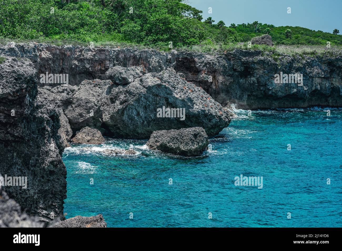 The photo shows the Atlantic Ocean with a rocky coast. The exotic island's beach contains many rocks and grottoes. The rocky landscape and the sea are Stock Photo