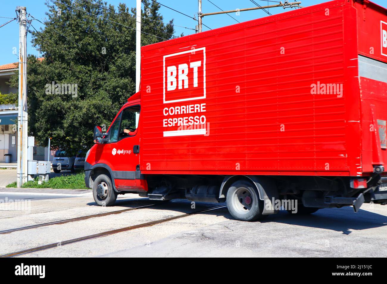BRT Bartolini Express Courier truck in movment on railroad intersection ...