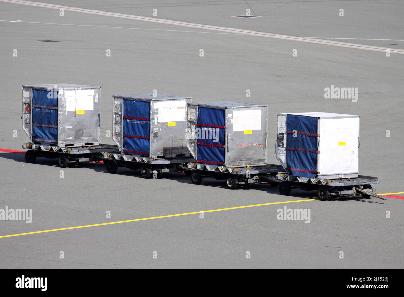 unit load devices on dollies at international airport Stock Photo