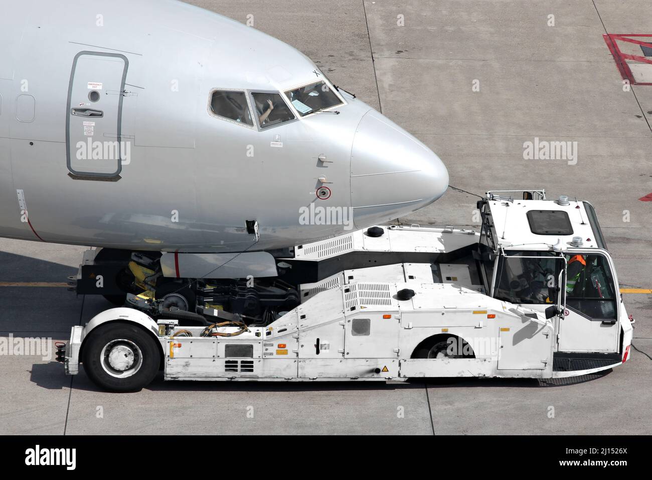 aircraft on pushback at international airport Stock Photo