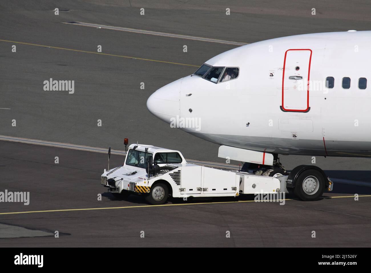 aircraft on pushback at international airport Stock Photo