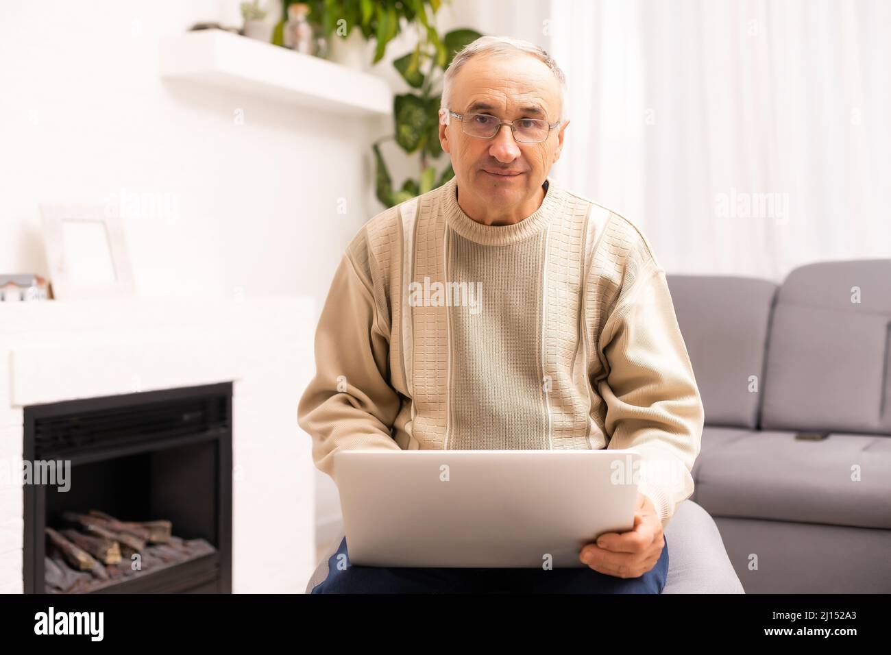Senior working on a laptop, elderly man. Stock Photo