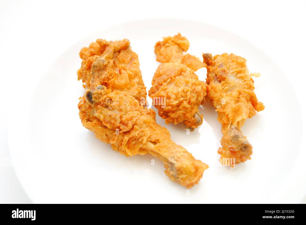 Hot and Spicy Chicken Pieces on a White Plate Stock Photo
