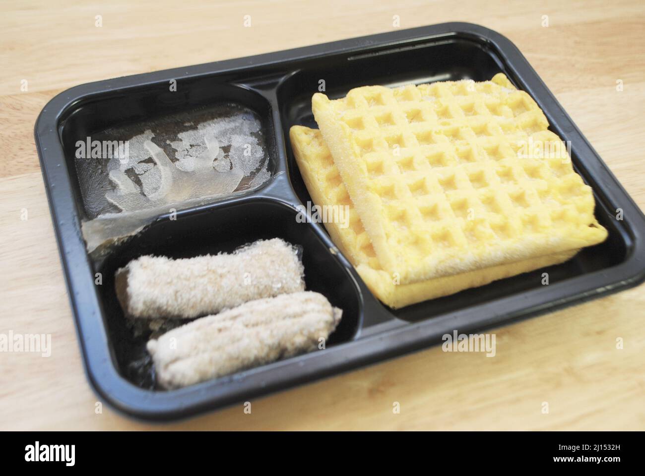 Frozen Microwavable Breakfast of Two Square Waffles Served with Sausage Links Stock Photo