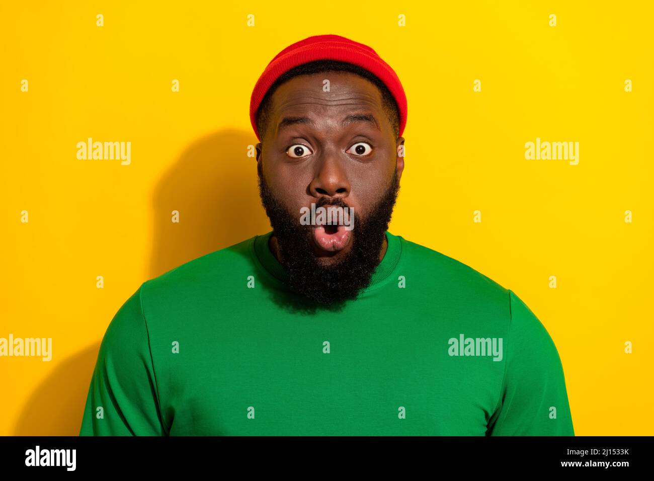 Portrait of attractive amazed stunned funny guy wearing cap staring