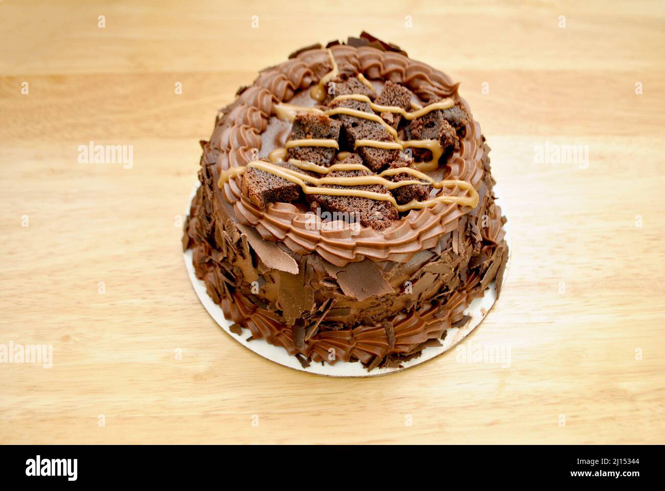 Whole fudge chocolate cake topped with brownies and caramel hires