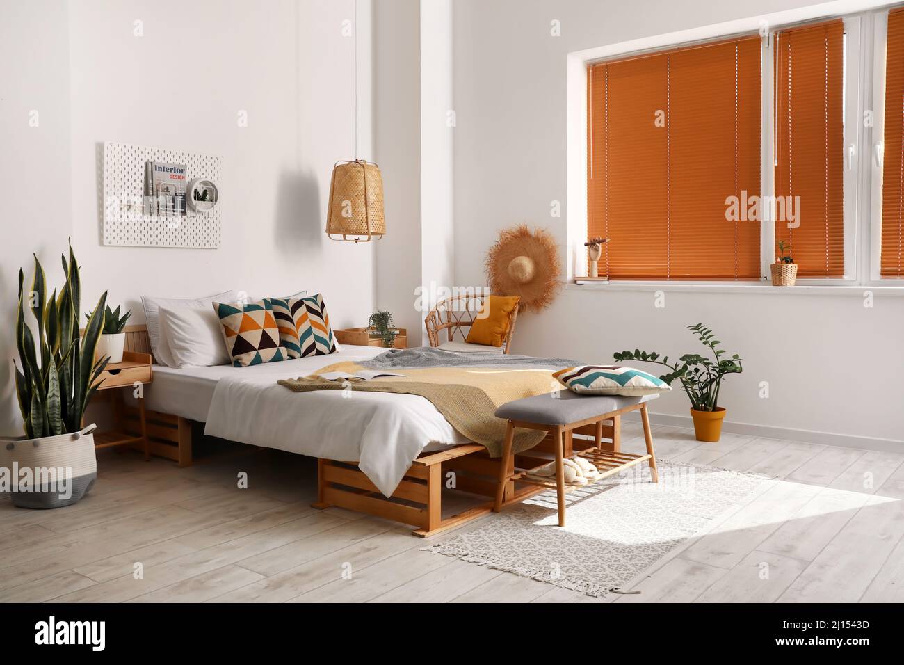 Interior of stylish bedroom with modern bench Stock Photo - Alamy