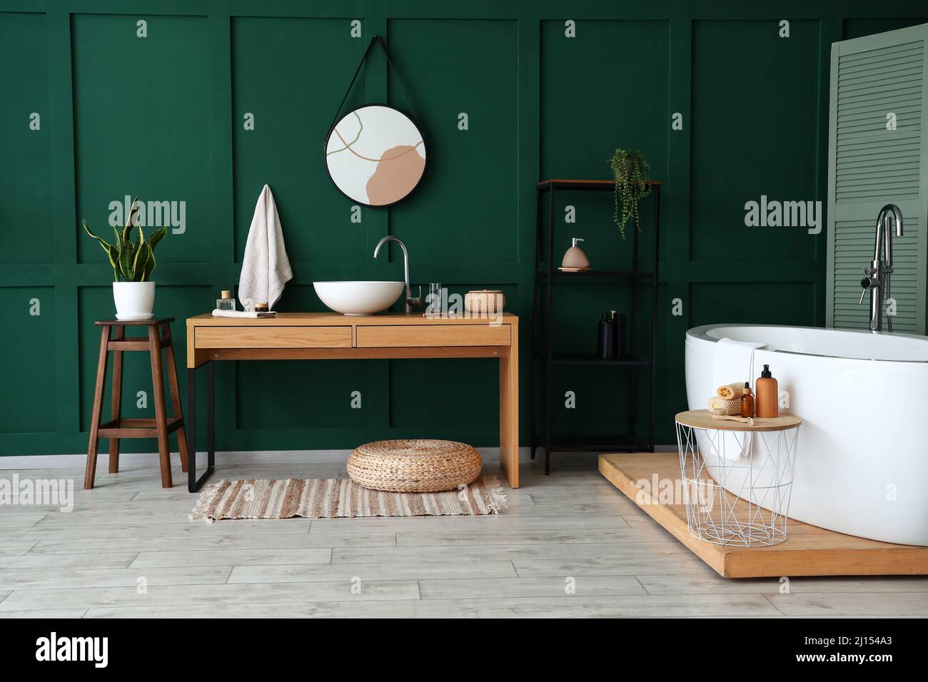 Interior of stylish room with sink, shelving unit and bathtub Stock