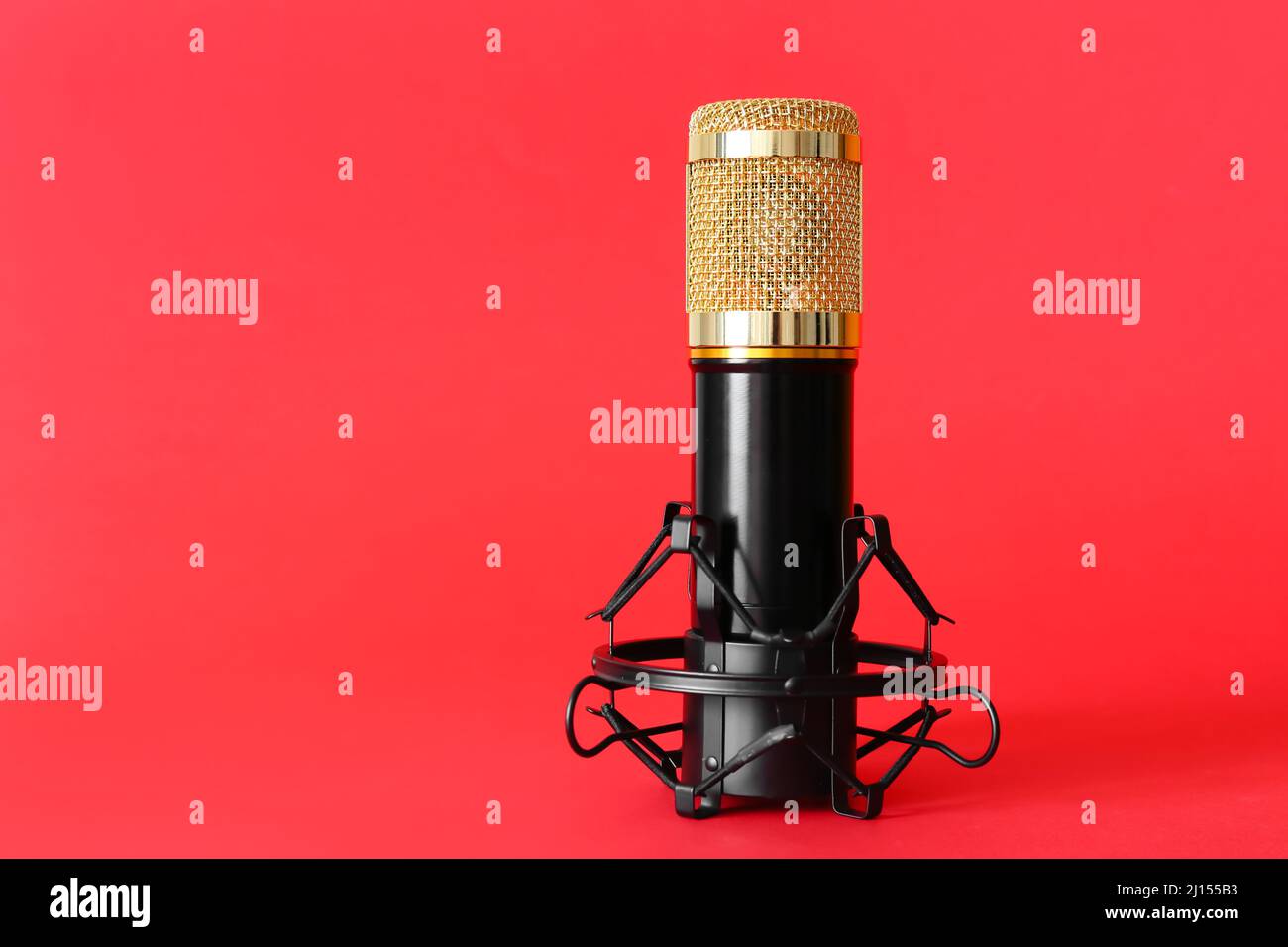 Stand with modern microphone on red background Stock Photo - Alamy