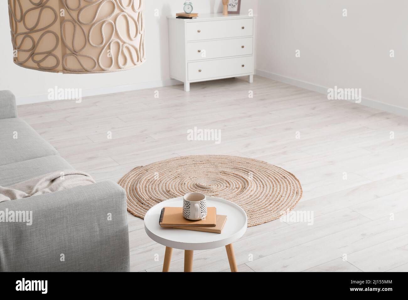 Round wicker carpet in interior of light living room Stock Photo - Alamy