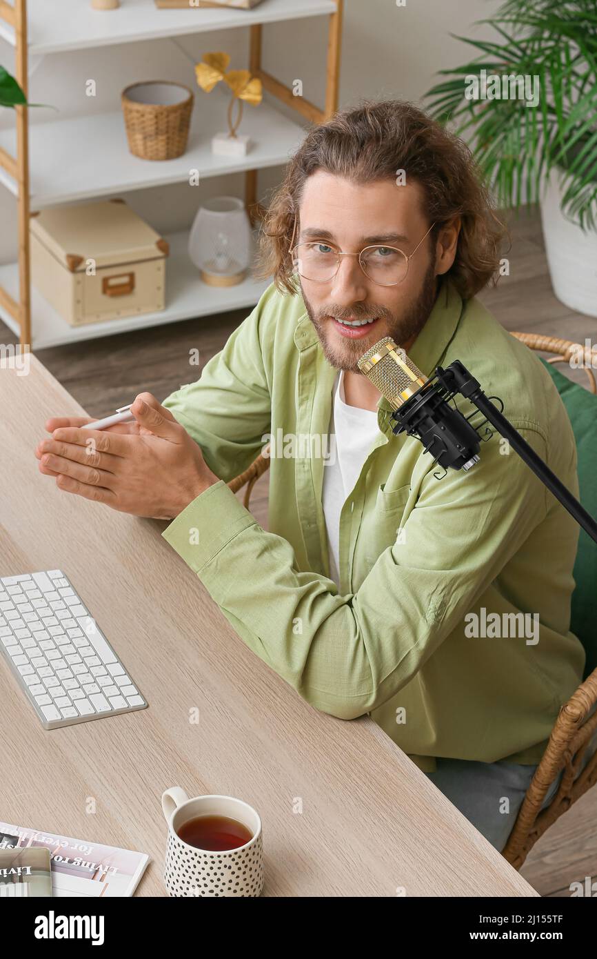 Streamer recording podcast using microphone hi-res stock photography ...