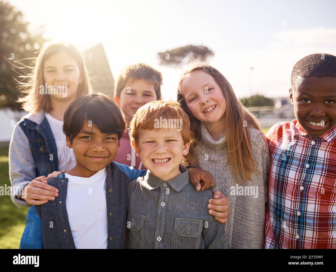 Theyre just being kids. Shot of young kids playing together outdoors. Stock Photo