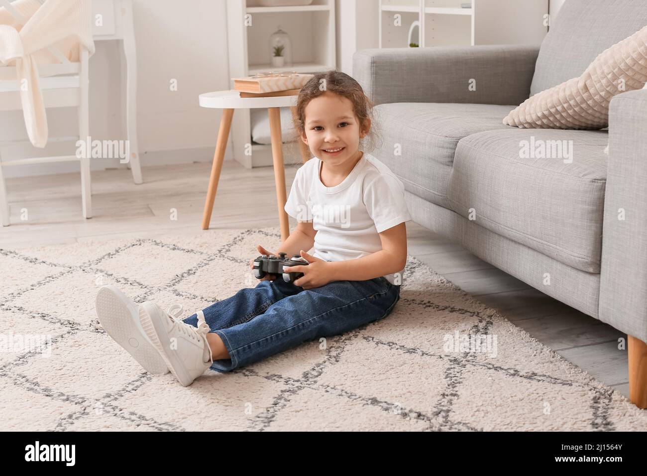 Little girl playing video games at home Stock Photo Alamy