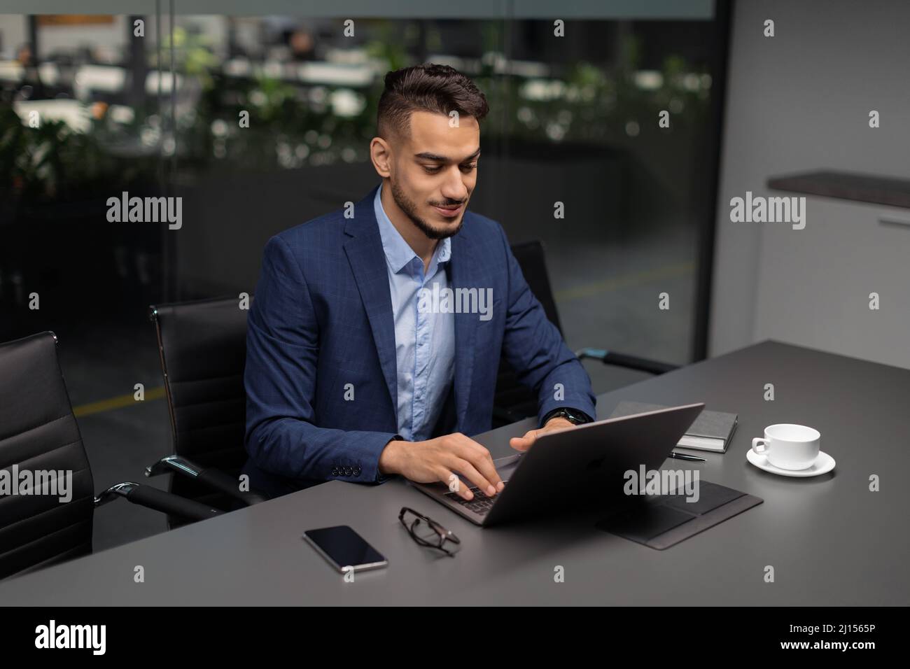 Handsome middle eastern entrepreneur working at modern office Stock Photo