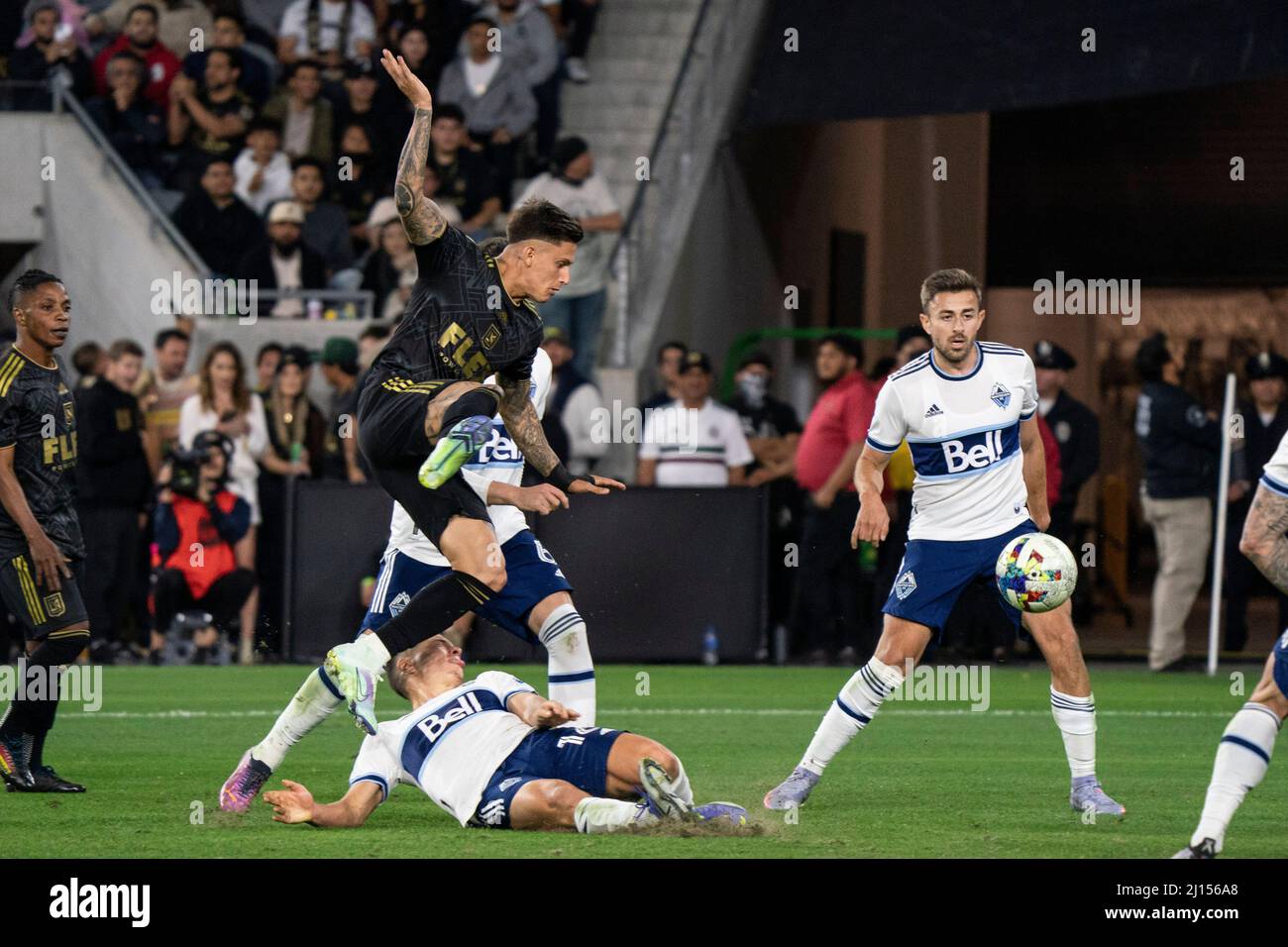 Vancouver Whitecaps midfielder Sebastian Berhalter (16) wins the ball with a slide tackle against Los Angeles FC midfielder Brian Rodríguez (17) durin Stock Photo