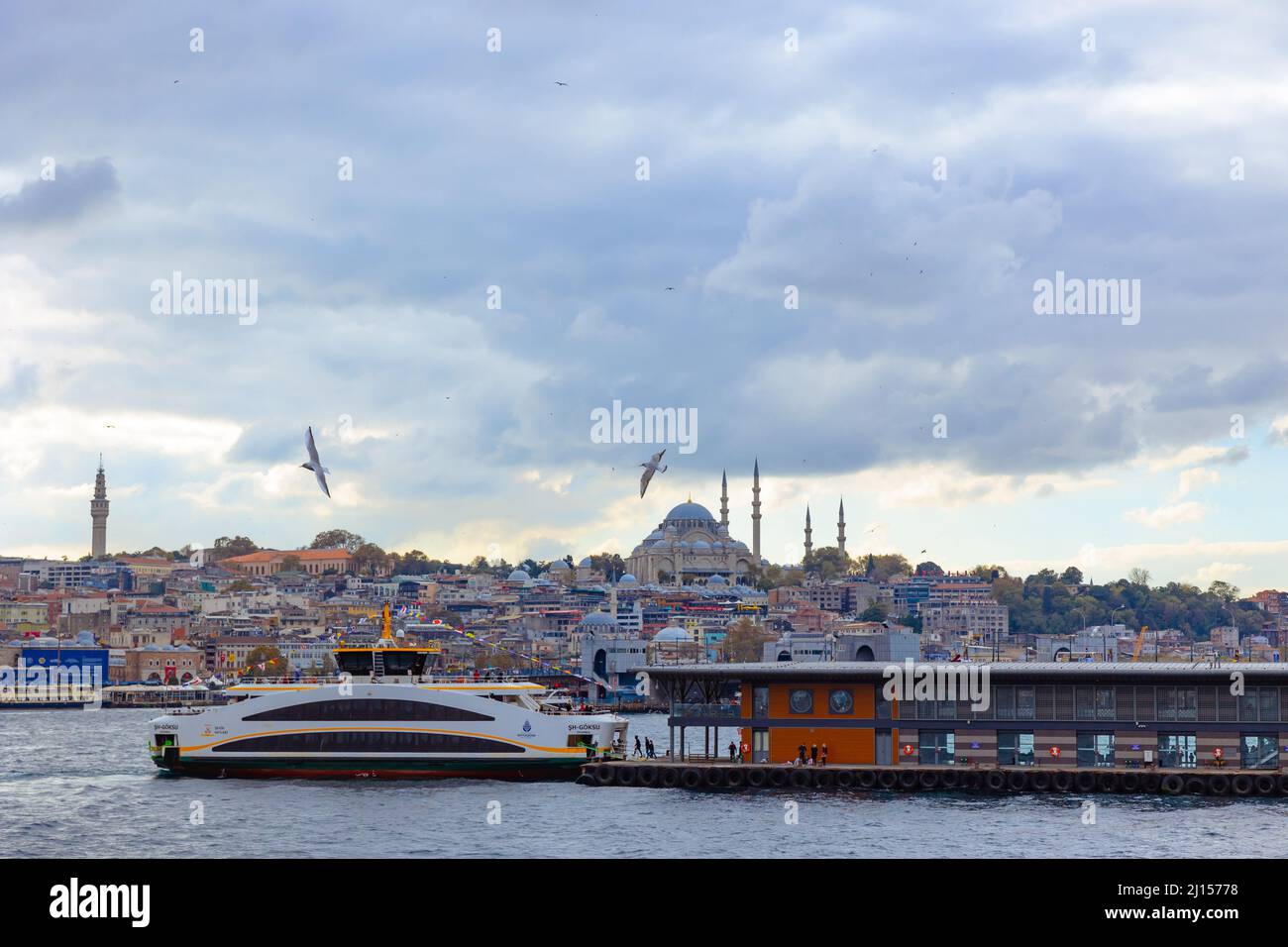 Istanbul. A ferry near the Karakoy Pier and Suleymaniye Mosque on ...