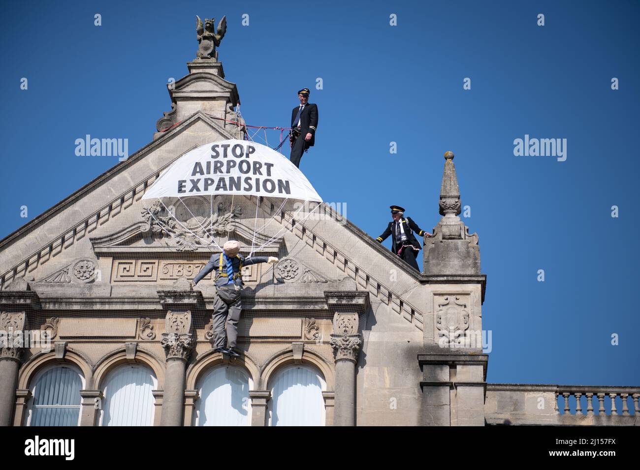 Weston-super-Mare, North Somerset, UK. 20th July 2021. Pictured: Activists wearing pilot costumes climb the top of Weston-super-Mare Town Hall and unf Stock Photo
