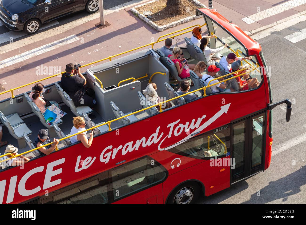 Nice, France - August 13, 2018: Tourists have a city tour on red double deck bus Stock Photo
