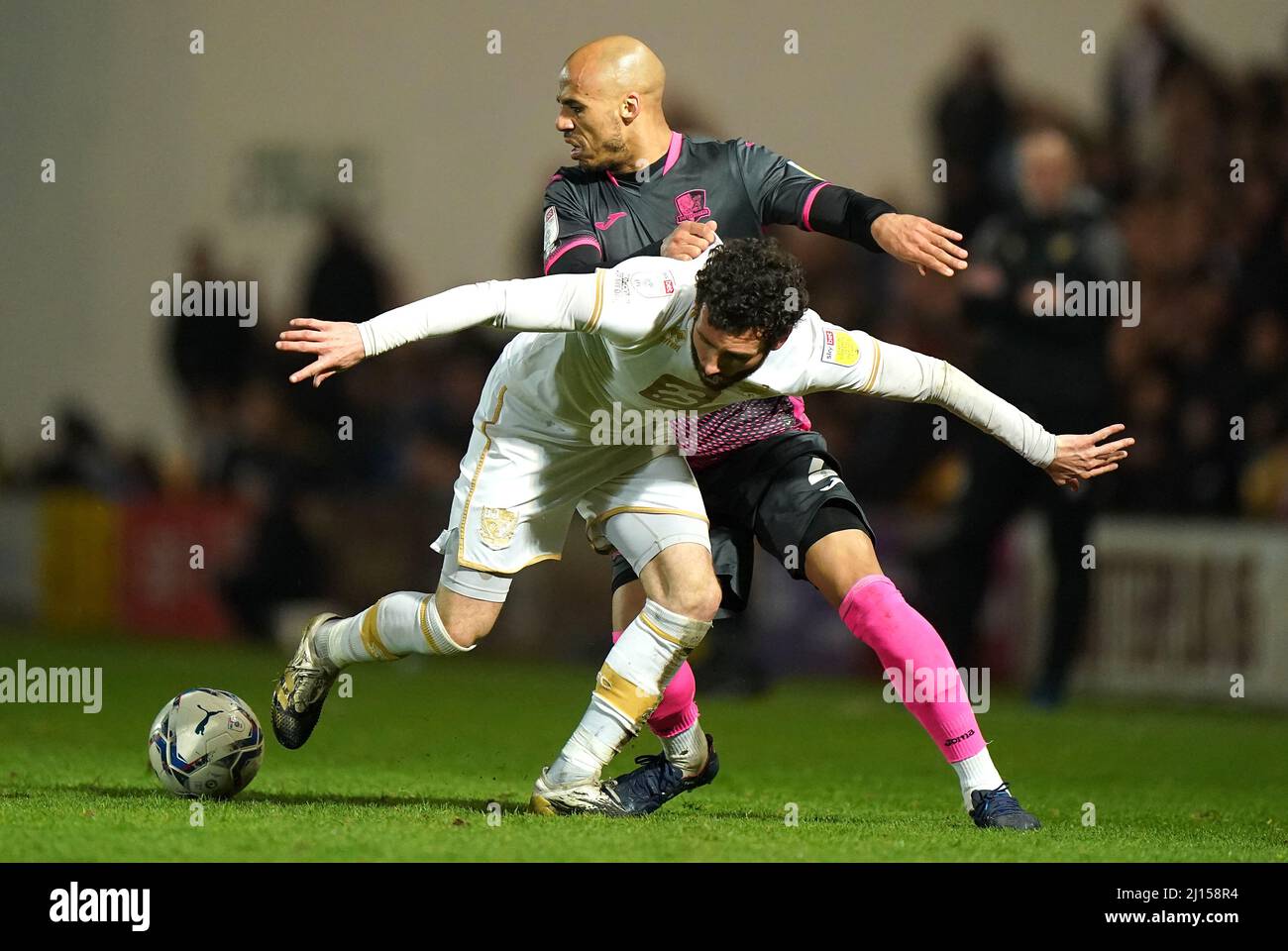 Port Vale's David Worrall (left) and Exeter City's Jake Caprice battle for the ball during the Sky Bet League Two match at Vale Park, Stoke-on-Trent. Picture date: Tuesday March 22, 2022. Stock Photo