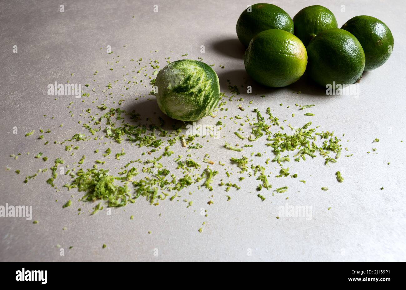 Grated lemon with zest of the rind spread on a white table and other