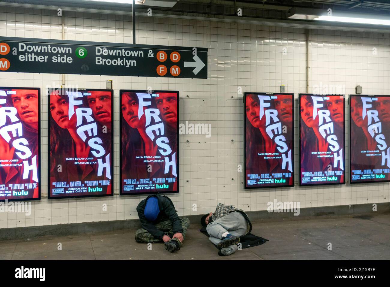 Homeless men sleep in the Bleecker Street subway station in New York on Saturday, March 12, 2022. (© Richard B. Levine) Stock Photo