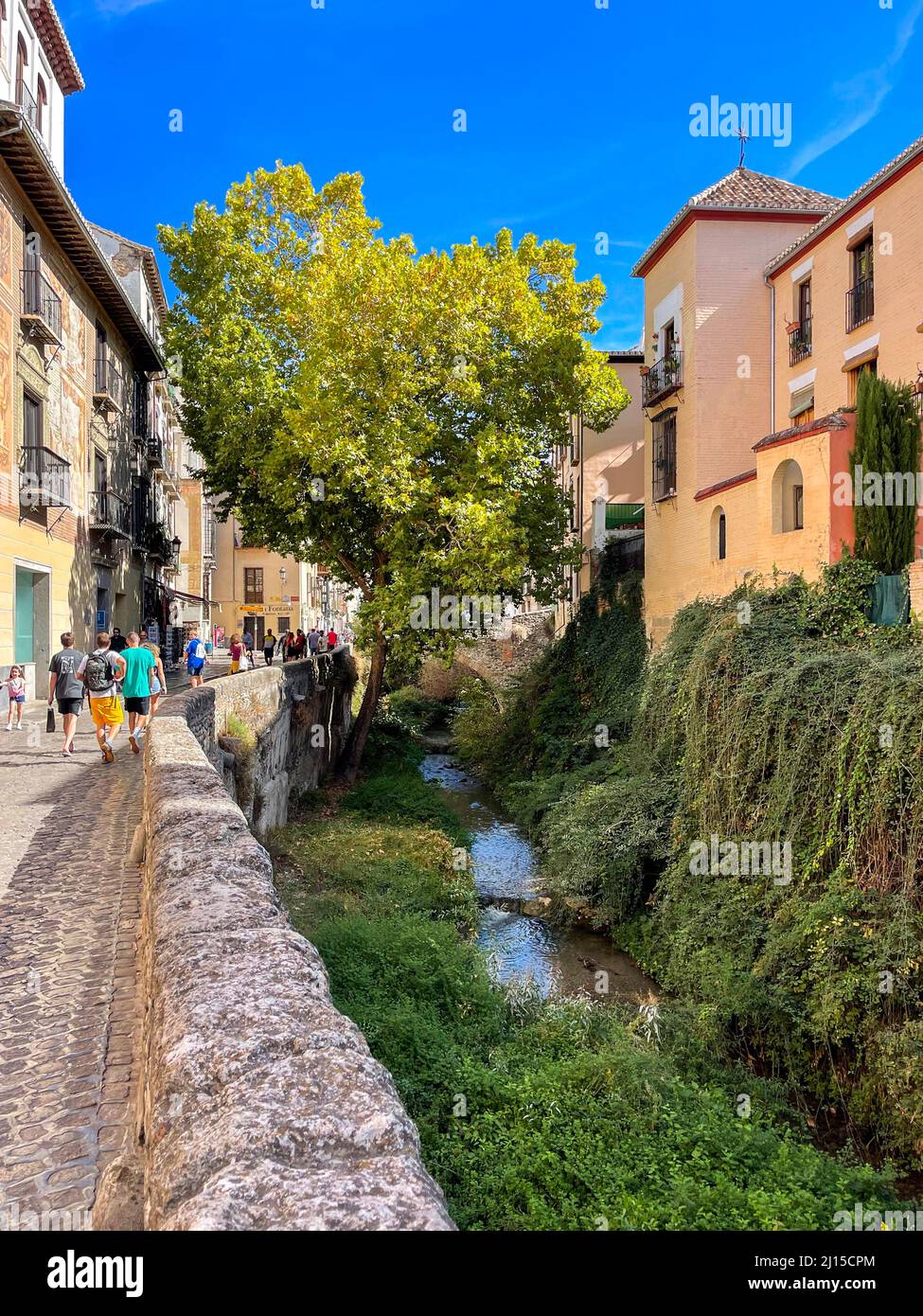 Tourists enjoying their walk in the picturesque district of Albaicin, in the Old Town of Granada, in Andalusia region, southern Spain, Europe. Stock Photo