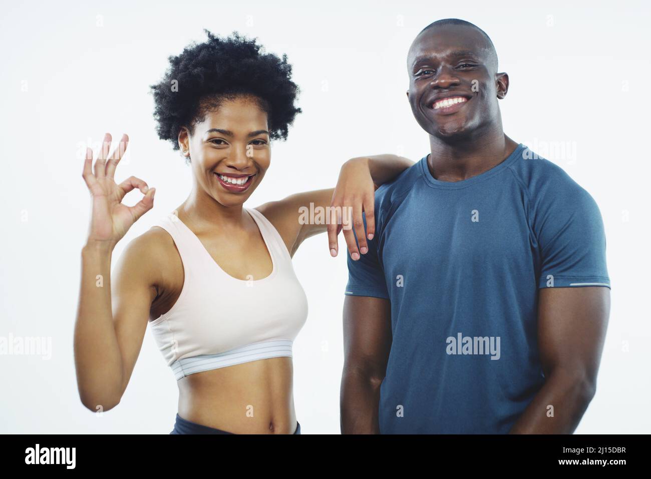 We offer top of the range fitness services. Studio shot of two young athletes posing together against a grey background. Stock Photo