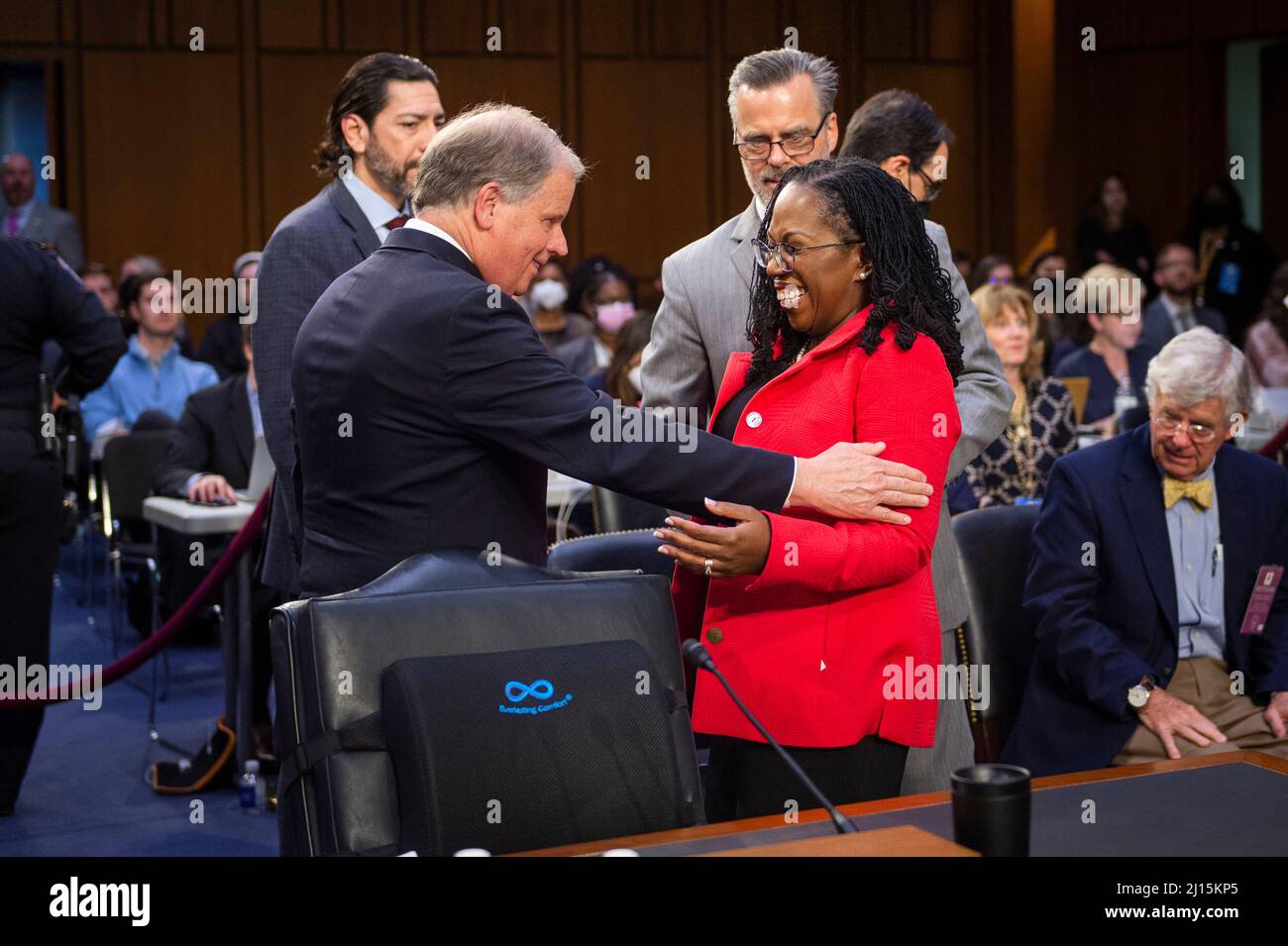 Washington, Vereinigte Staaten. 22nd Mar, 2022. Former United States Senator Doug Jones (Democrat of Alabama), left, talks with Judge Ketanji Brown Jackson, right, as she returns from a break on the second day of her Senate nomination hearings to be an Associate Justice of the Supreme Court of the United States, in the Hart Senate Office Building in Washington, DC, Tuesday, March 22, 2022. Credit: Rod Lamkey/CNP/dpa/Alamy Live News Stock Photo