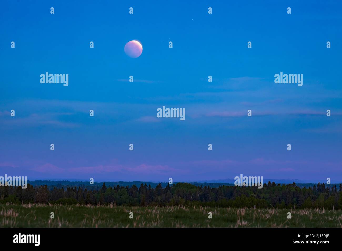 Red Moon over the Rocky Mountains, Canada Stock Photo