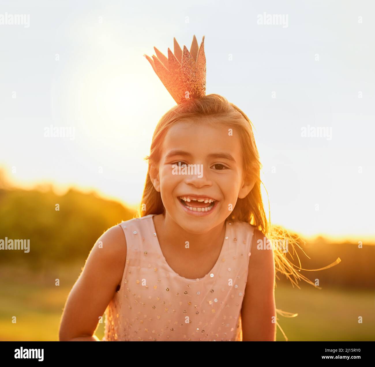 If the crown fits, there is no reason to frown. Shot of an adorable little girl playing outdoors. Stock Photo