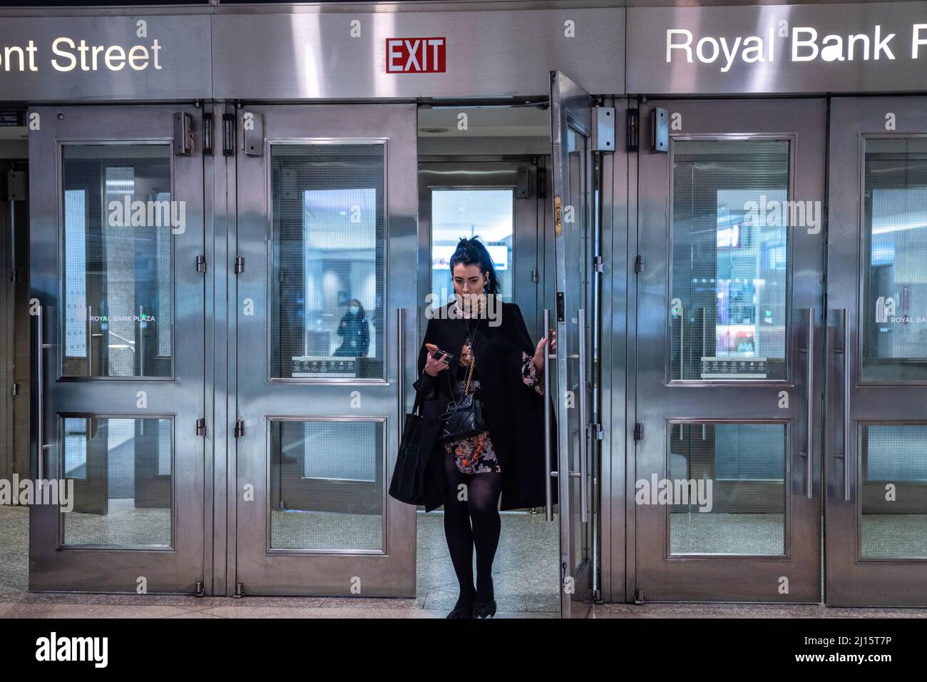 Toronto, Canada. 22nd Mar, 2022. A maskless woman stands outside the royal bank. Ontario's mask mandate against COVID-19 has been lifted after almost a year and a half, meaning that masks are no longer required to be worn in most indoor public areas of Toronto, Canada. Credit: SOPA Images Limited/Alamy Live News Stock Photo
