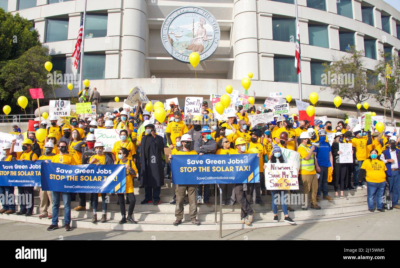 San Francisco, CA - Jan 13, 2022: Unidentified participants in a Rally to save Solar power in California. Holding signs, marching to the State buildin Stock Photo