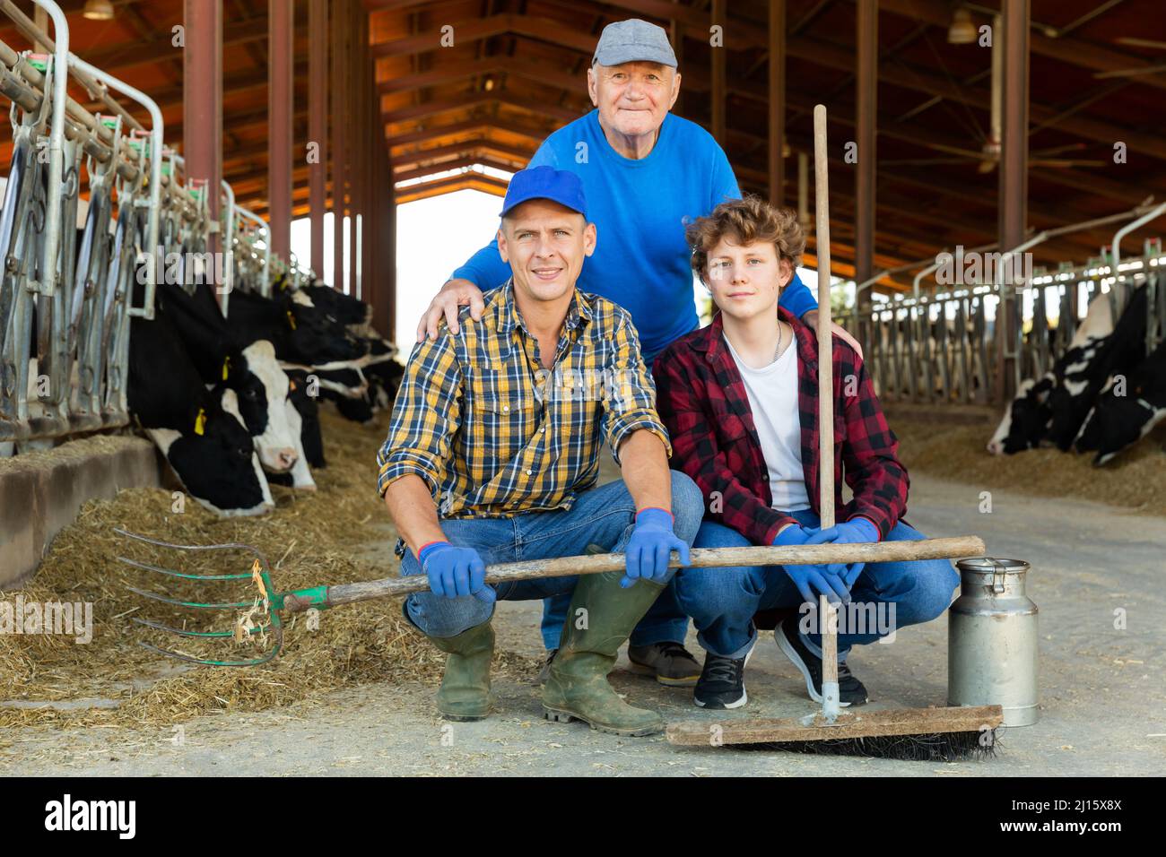 Family-owned livestock business - three farmers of different ages in ...