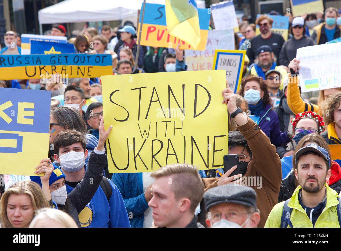 San Francisco, CA - Feb 26, 2022:  Unidentified participants at United We Stand For Ukraine Protest holding signs. Advocating for solidarity with the Stock Photo
