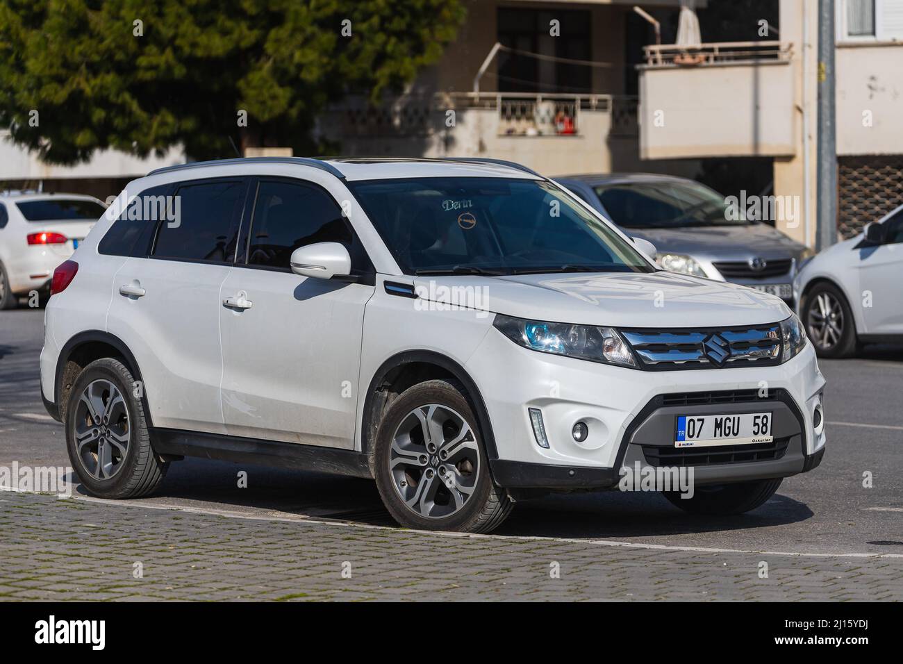 Side; Turkey – March 03 2022:    white  Suzuki Grand Vitara   is parked  on the street on a warm summer day against the backdrop of a  buildung, garde Stock Photo