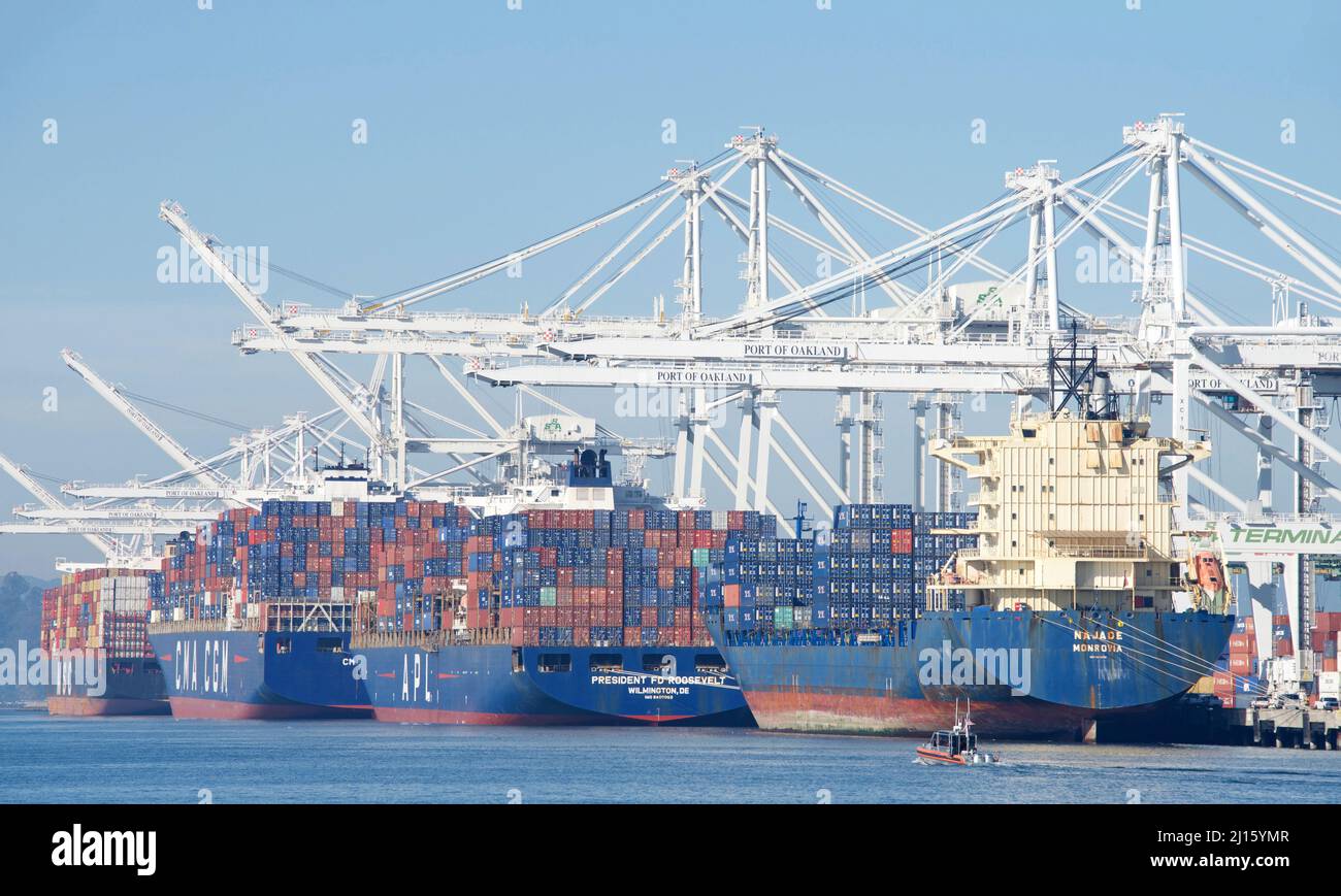 Oakland, CA - Jan 10, 2022: Multiple cargo ships loading at the Port of Oakland, the fifth busiest port in the United States. Stock Photo