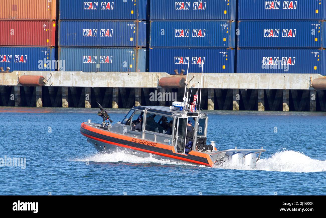 Oakland, CA - March 10, 2022: Small Gun Mounted Coast Guard cutter passing the Port of Oakland. Stock Photo