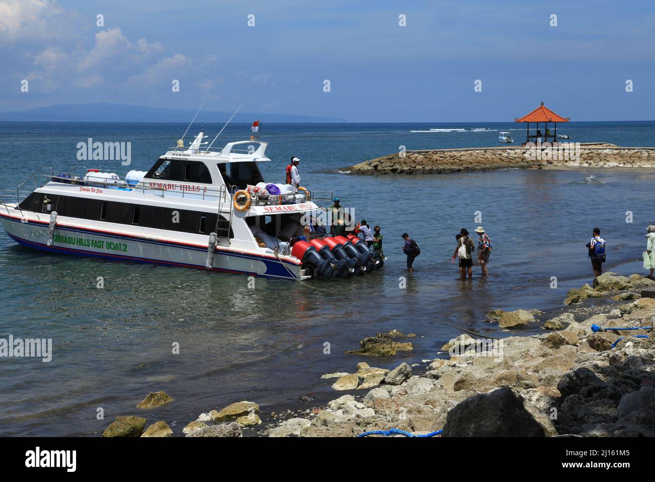 A fast boat with five large outboard engines at Sanur Port waiting to take passengers to Nusa Penida island in Bali, Indonesia. Stock Photo