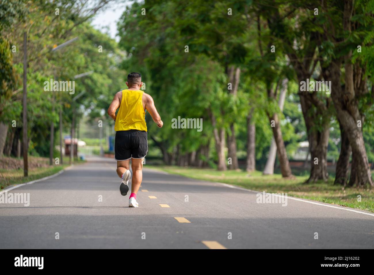Backside of senior man in fitness wear running in a park. Healthy ...