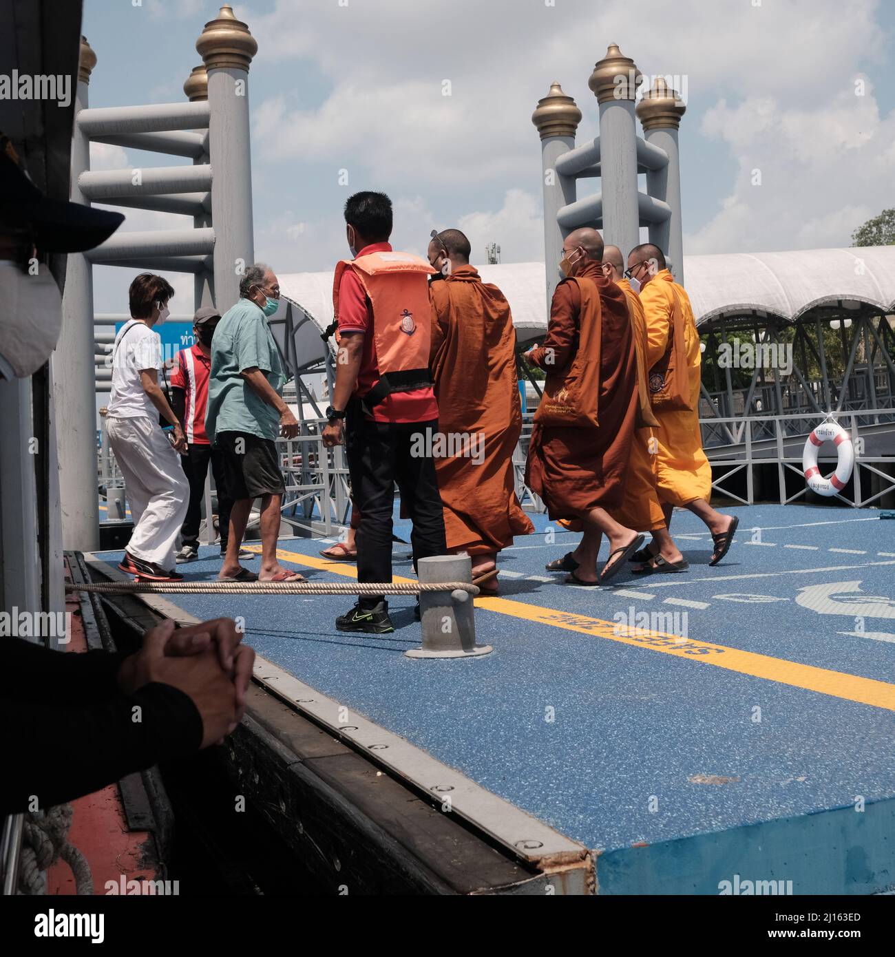 Worker on Orange Flag Express Boat Seaman Boatswain man on the ropes